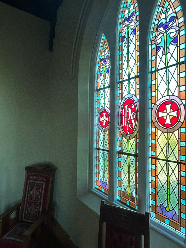 Stained glass window at the Convent, featuring intricate patterns and vibrant colors that add a touch of historic charm and artistic beauty to the space.